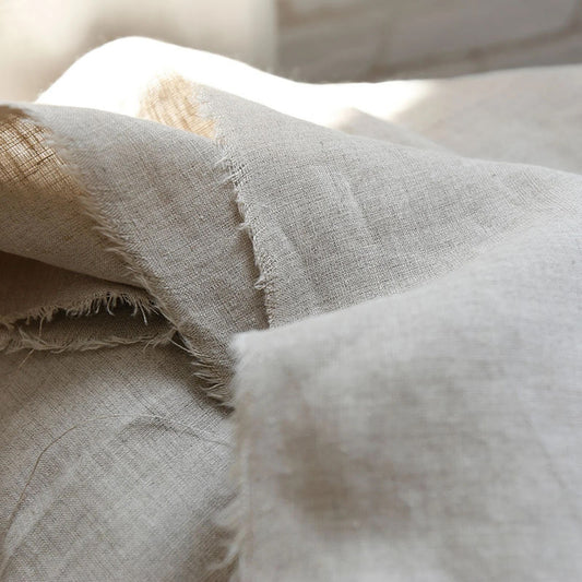 Natural oatmeal hemp fabric by the meter draped in soft folds