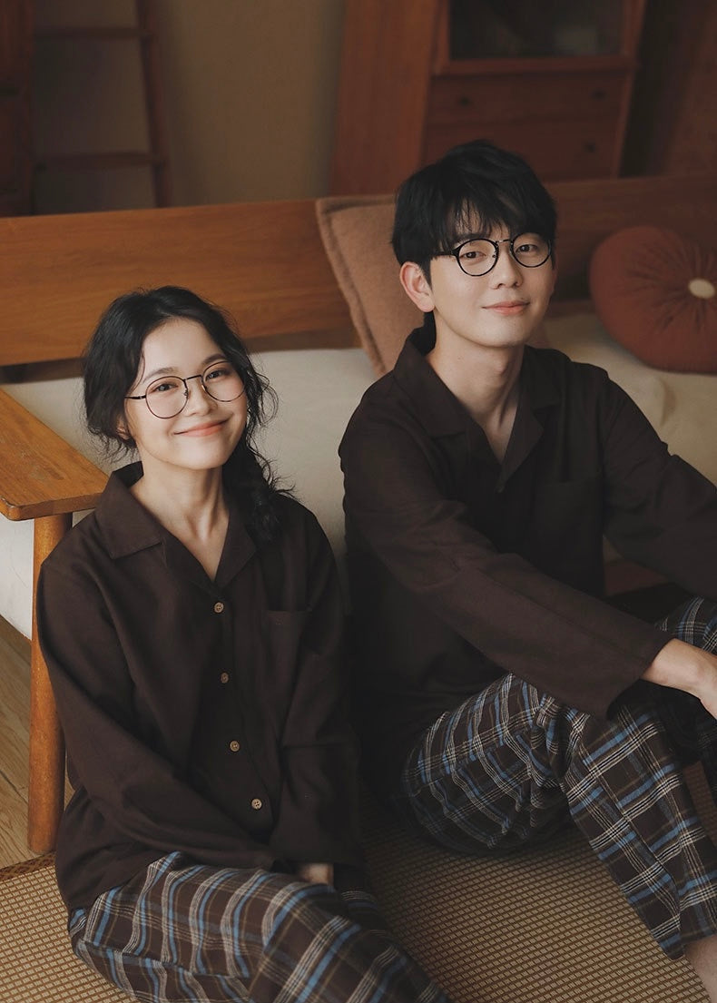 Couple wearing coffee brown cotton pajama shirts with brown and blue plaid pants