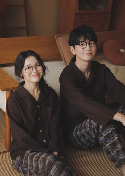 Couple wearing coffee brown cotton pajama shirts with brown and blue plaid pants