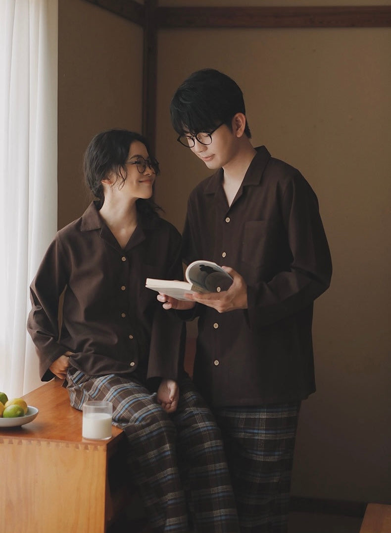 Matching coffee brown pajamas for women and men by the window
