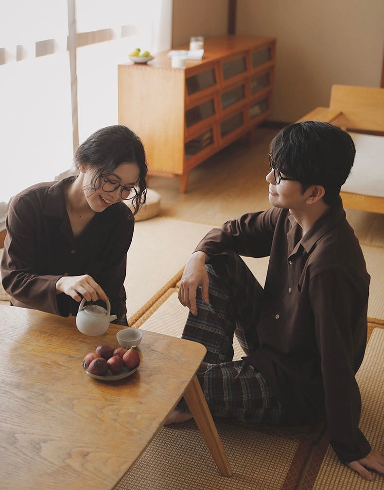 Couple relaxing in coffee brown and plaid pajamas
