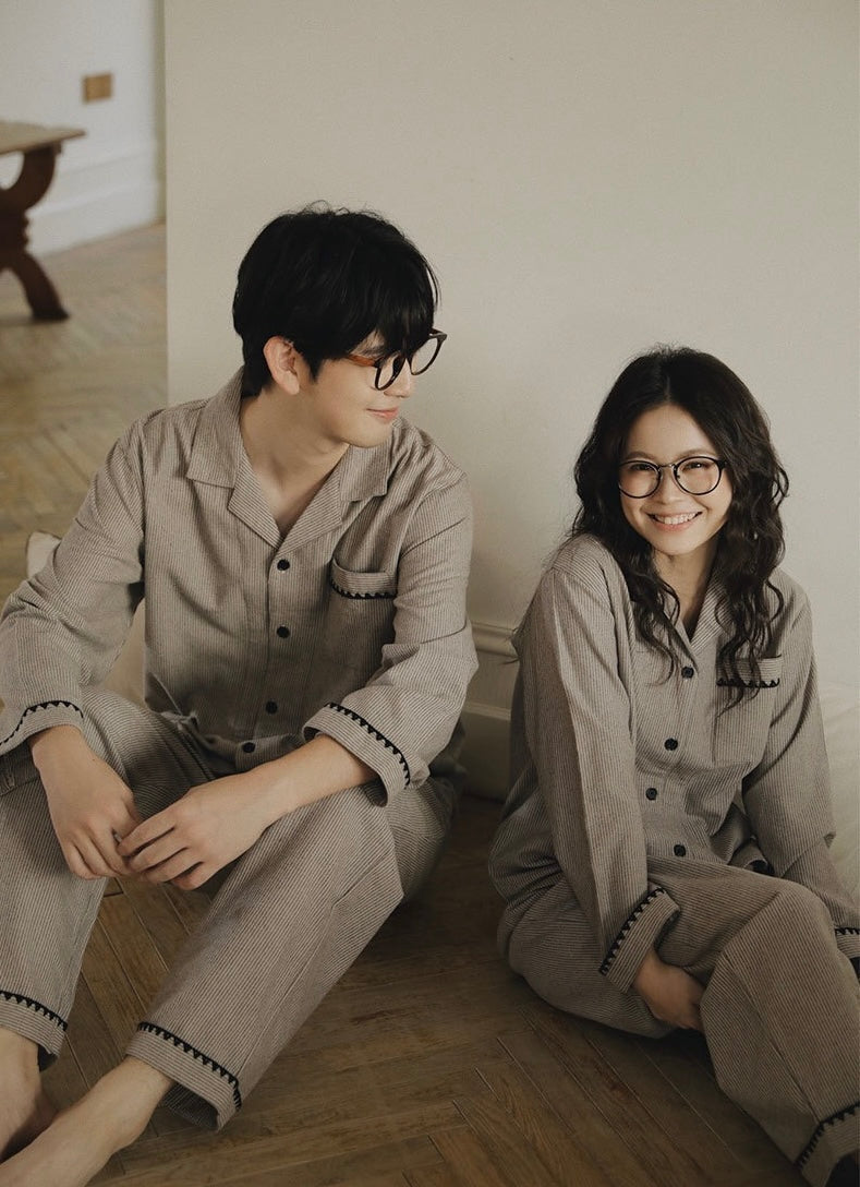 Couple seated on the floor in matching cotton flannel pajamas