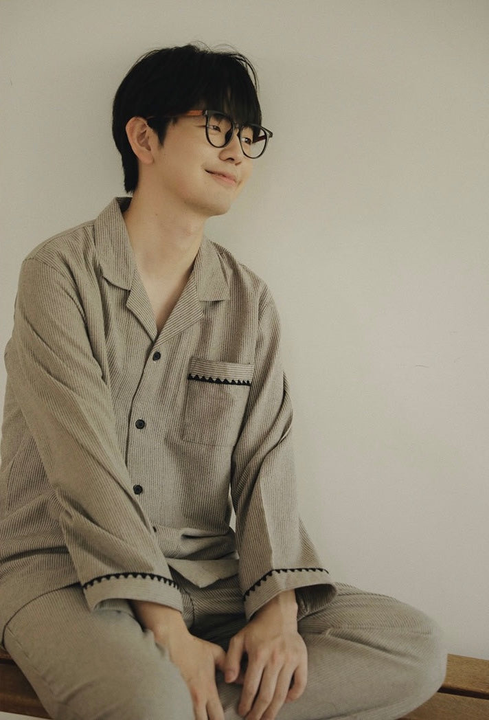 Men's striped pajama top showing collar, chest pocket and cuff trim
